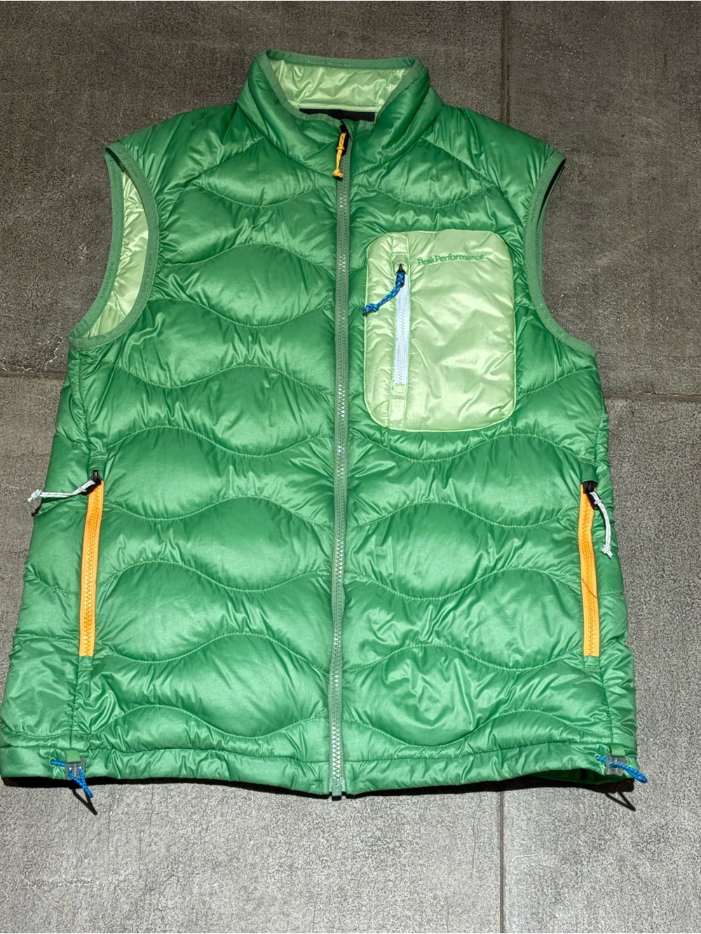 Peak Performance Green Utility Puffer Vest with Yellow Zipper Accents